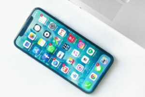 white smartphone near laptop